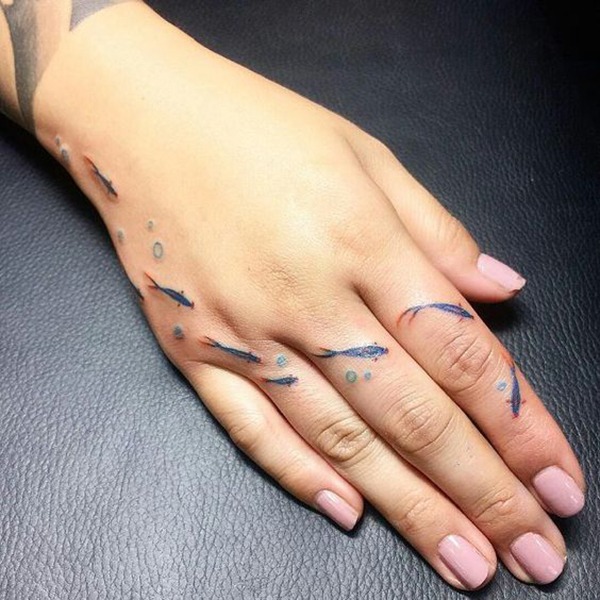 Tiny Koi Swimming Along with Hand Tattoo Design