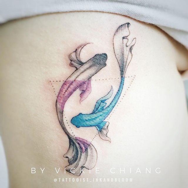 Two Swirling Fish with Sections of Color Tattoo Design