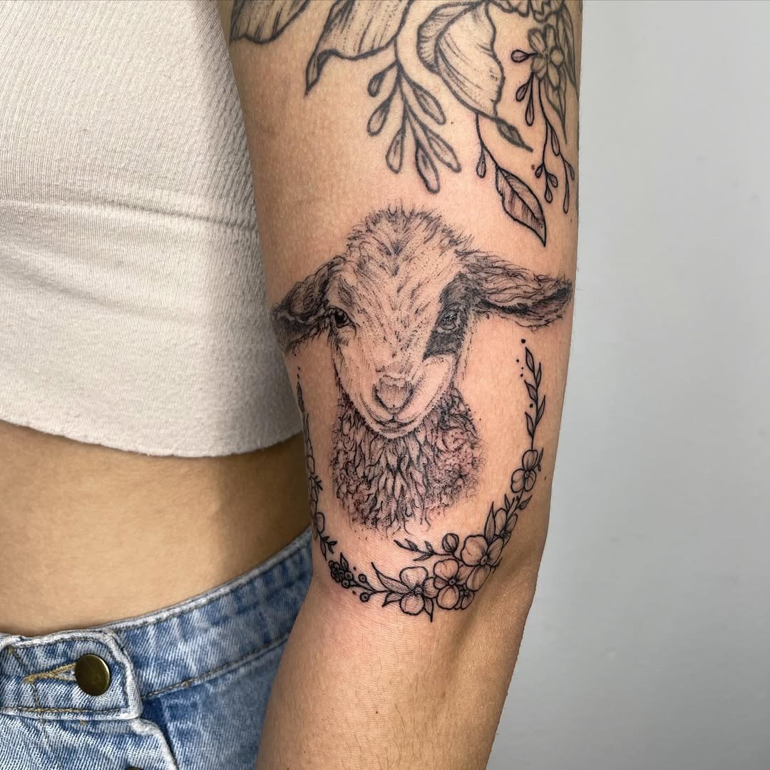 A Cute Lamb Tattoo Surrounded by Floral Elements Tattoo Design