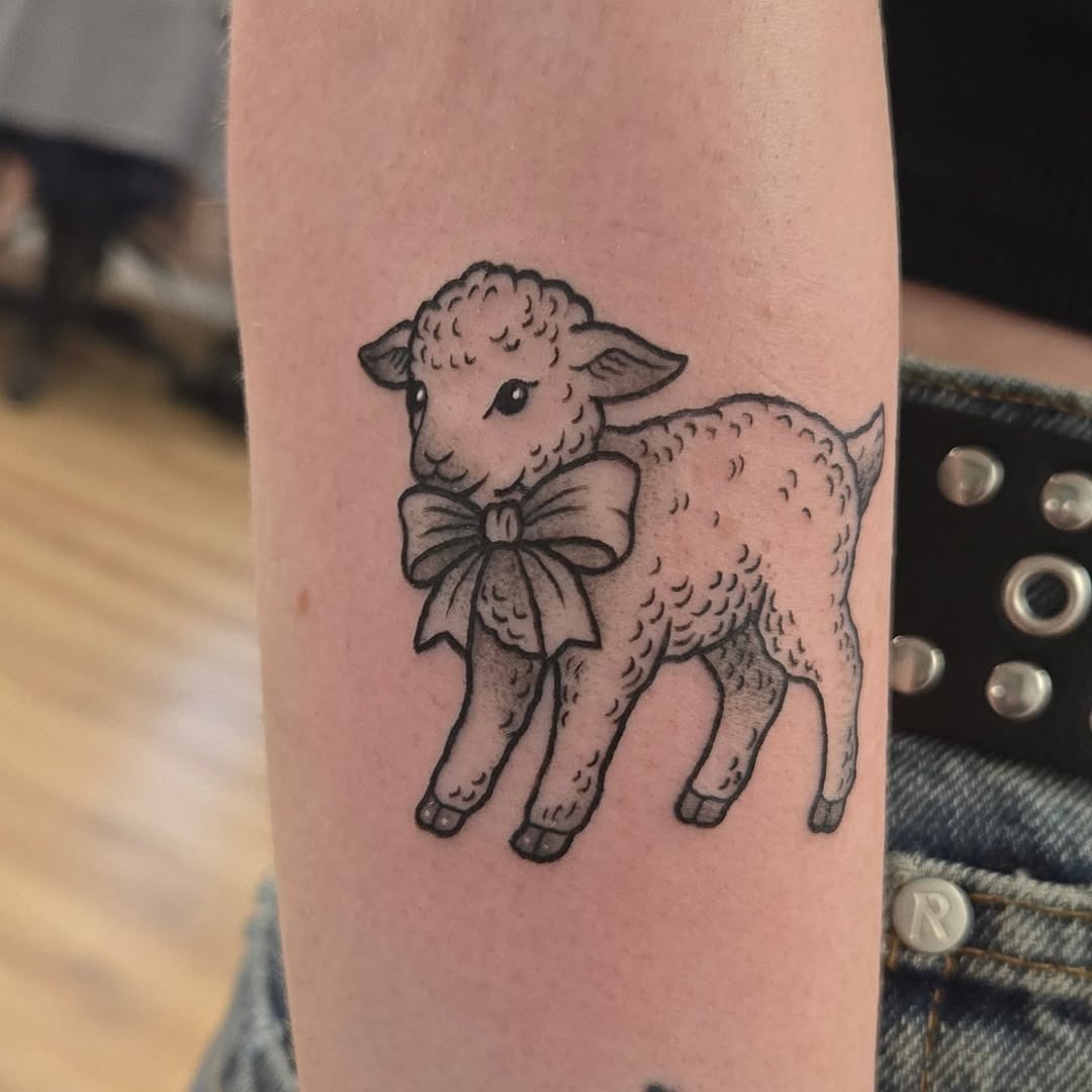 Adorable lamb tattoo with a sweet bow Tattoo Design