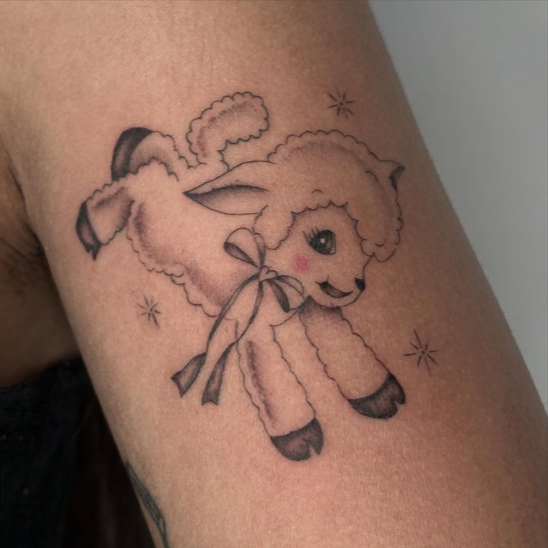 Charming and whimsical lamb tattoo with a bow Tattoo Design