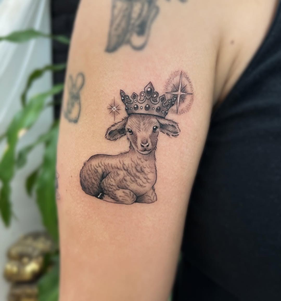Charming crowned lamb tattoo design on arm Tattoo Design