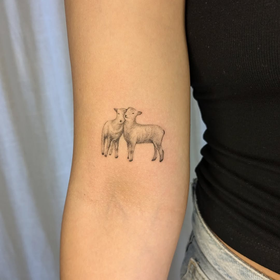 Delightful twin lambs tattoo on arm Tattoo Design