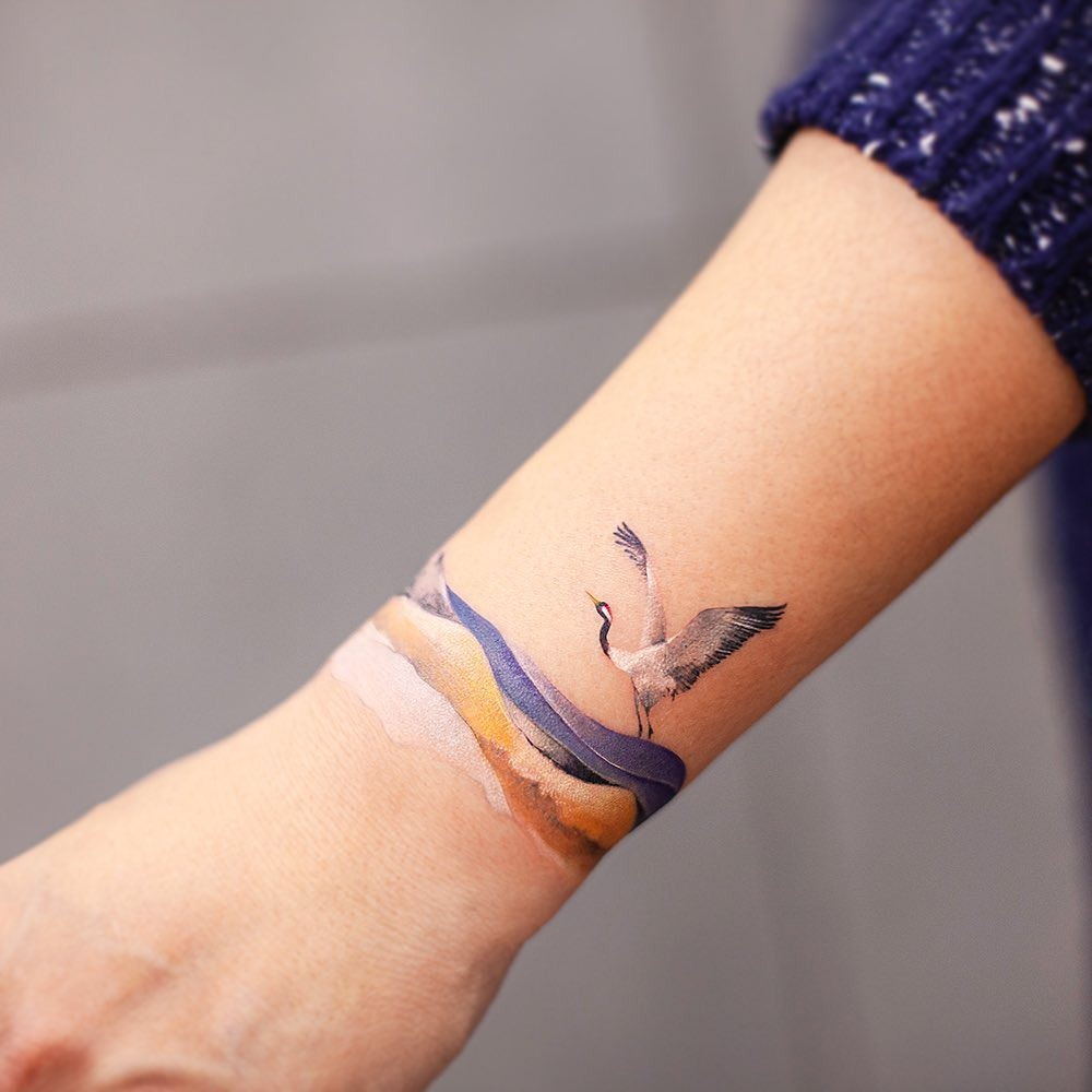 Elegant landscape tattoo with a soaring crane Tattoo Design