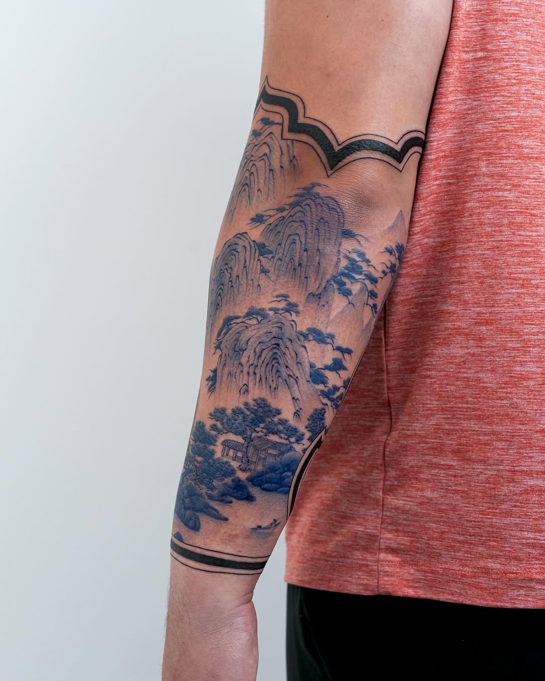 Stunning blue landscape tattoo on the arm Tattoo Design