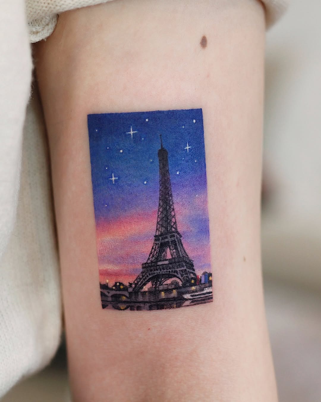 Stunning Eiffel Tower tattoo with pastel sunset hues Tattoo Design