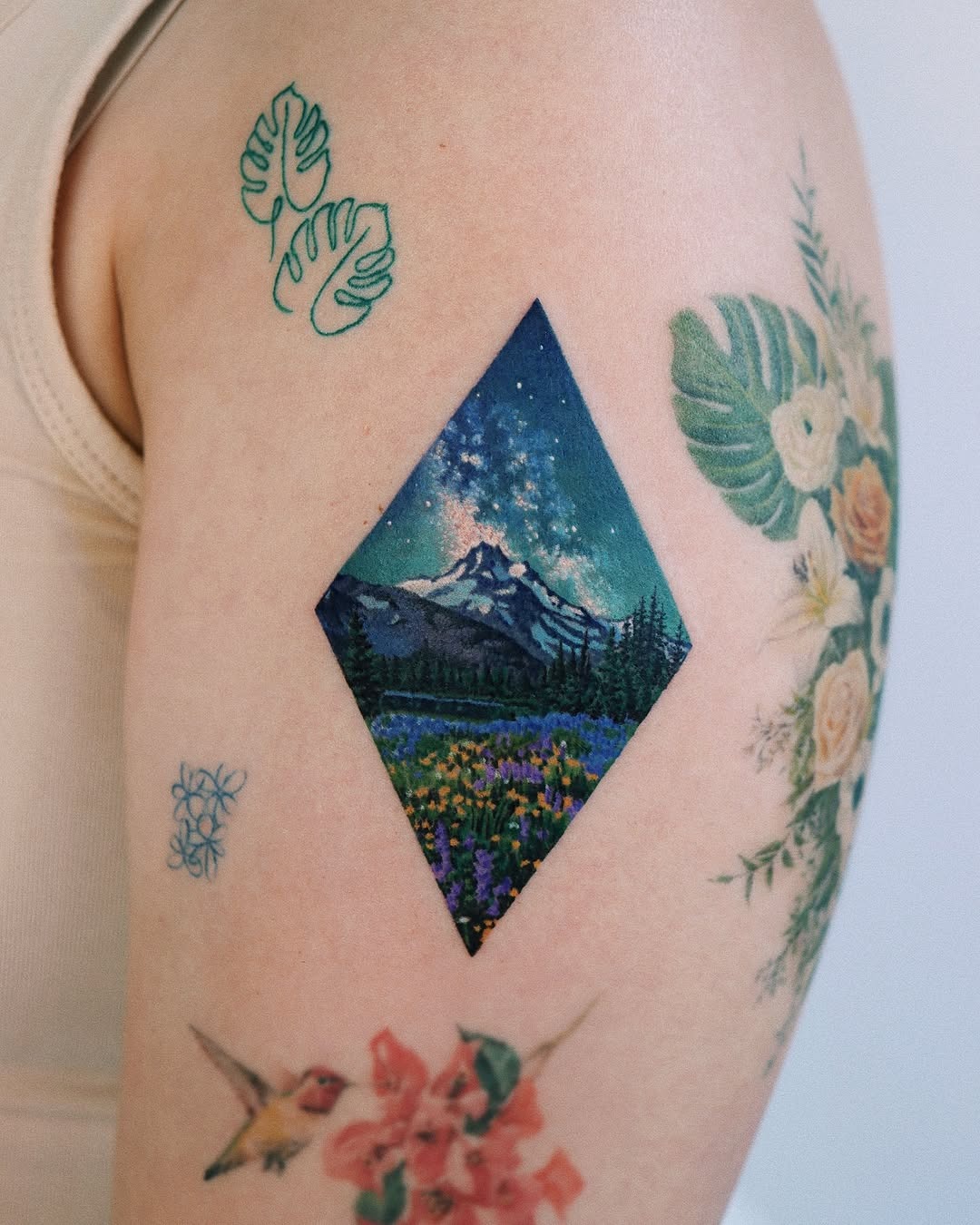 Stunning mountain scene captured in vibrant ink. Tattoo Design