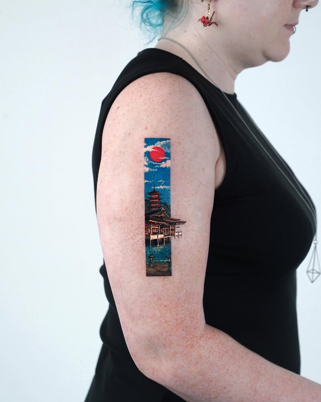 Stunning sunset tattoo featuring a Japanese pavilion Tattoo Design