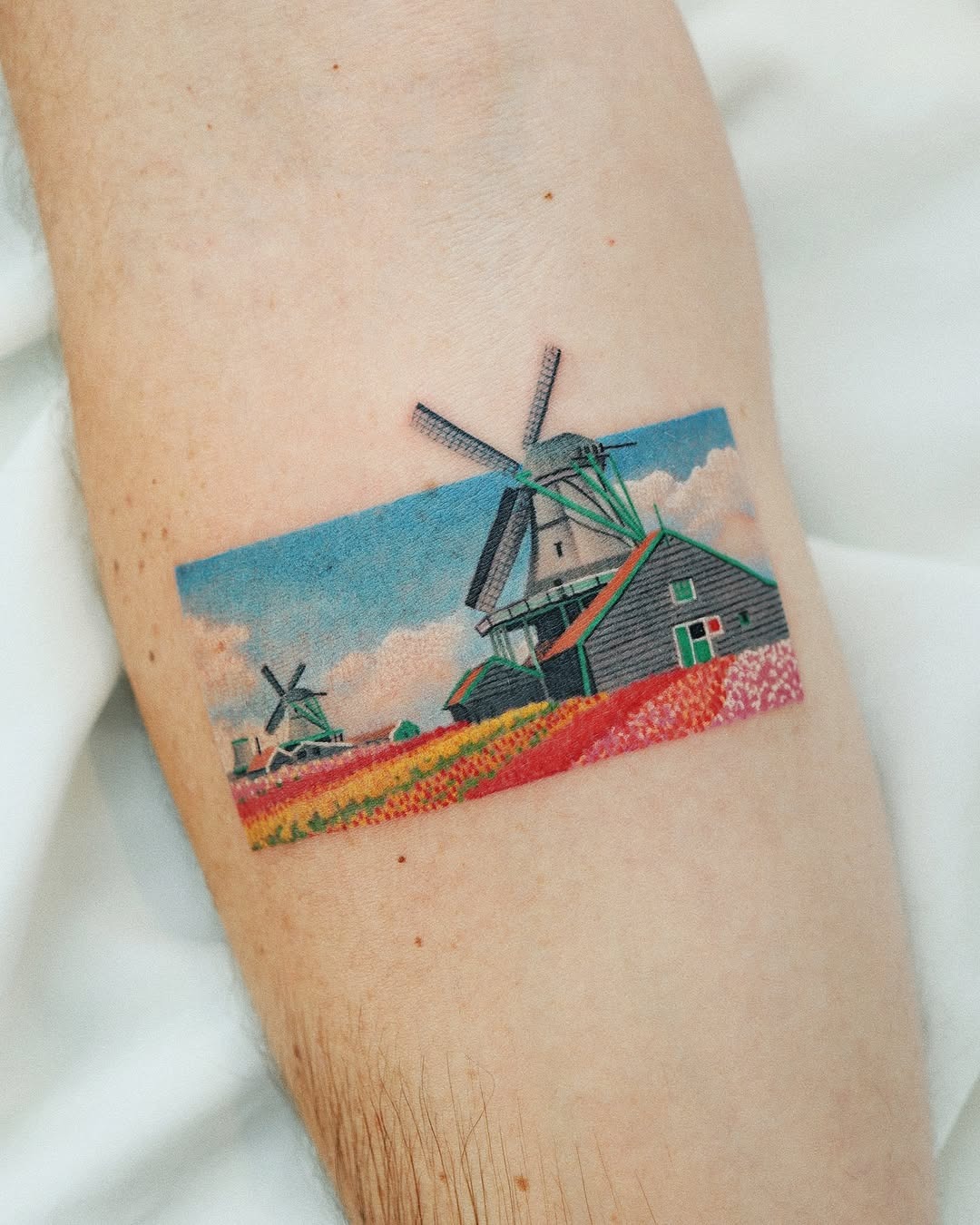 Vibrant landscape tattoo showcasing a serene windmill scene Tattoo Design