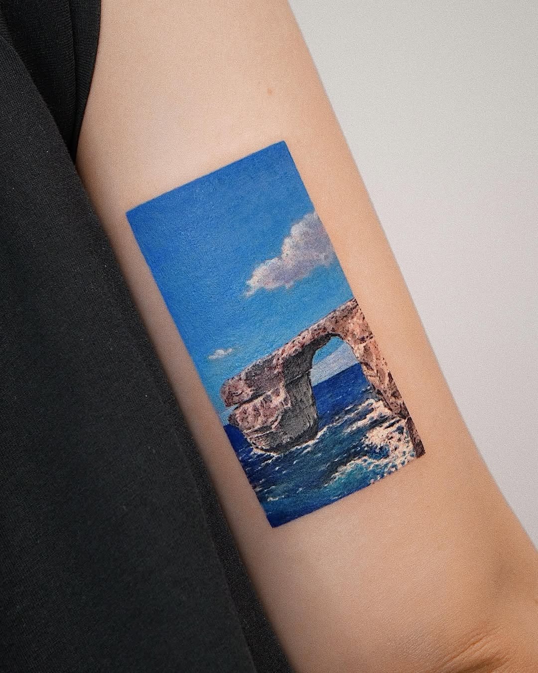 Vibrant ocean archway tattoo on arm Tattoo Design