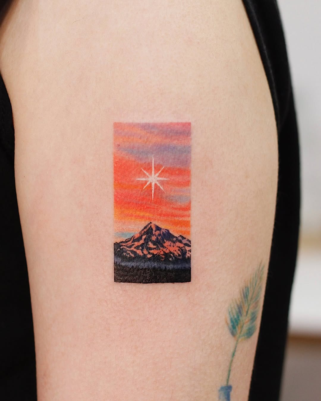 Vibrant sunset mountain tattoo with star detail Tattoo Design
