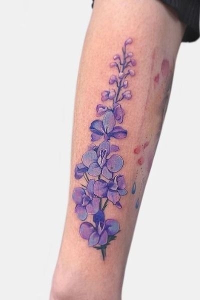 Fine-line larkspur stem with soft shaded blooms Tattoo Design