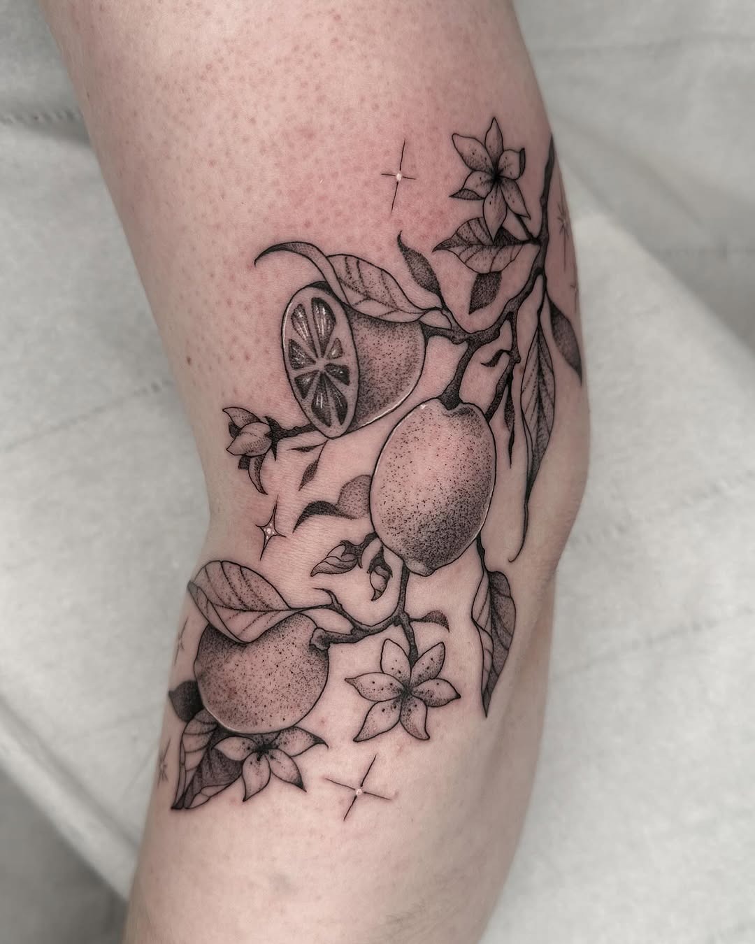 Beautiful lemon tattoo with floral elements Tattoo Design
