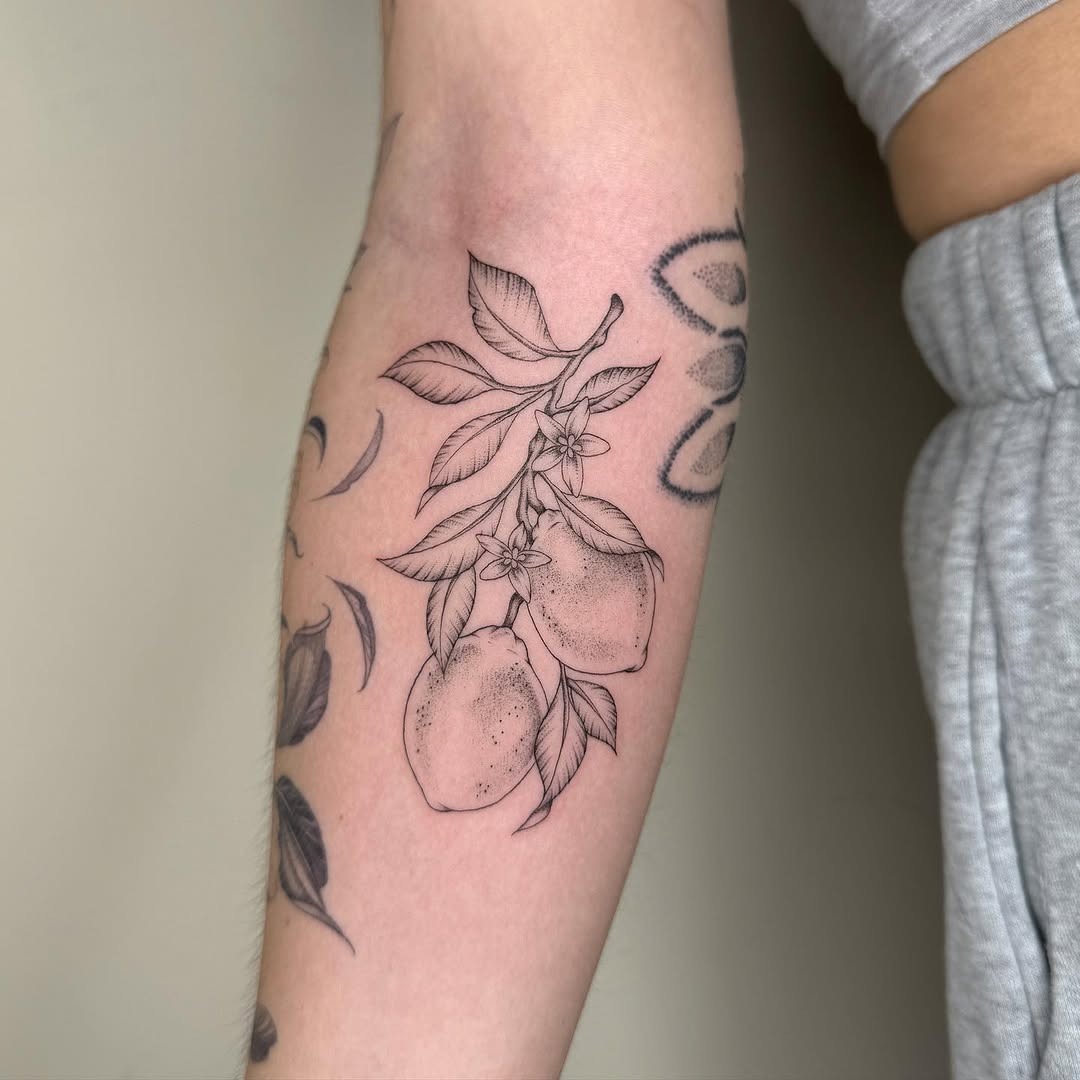 Elegant lemon tattoo with delicate floral details Tattoo Design