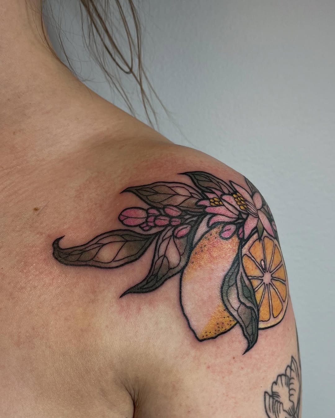Vibrant Lemon Tattoo with Floral Elements Tattoo Design