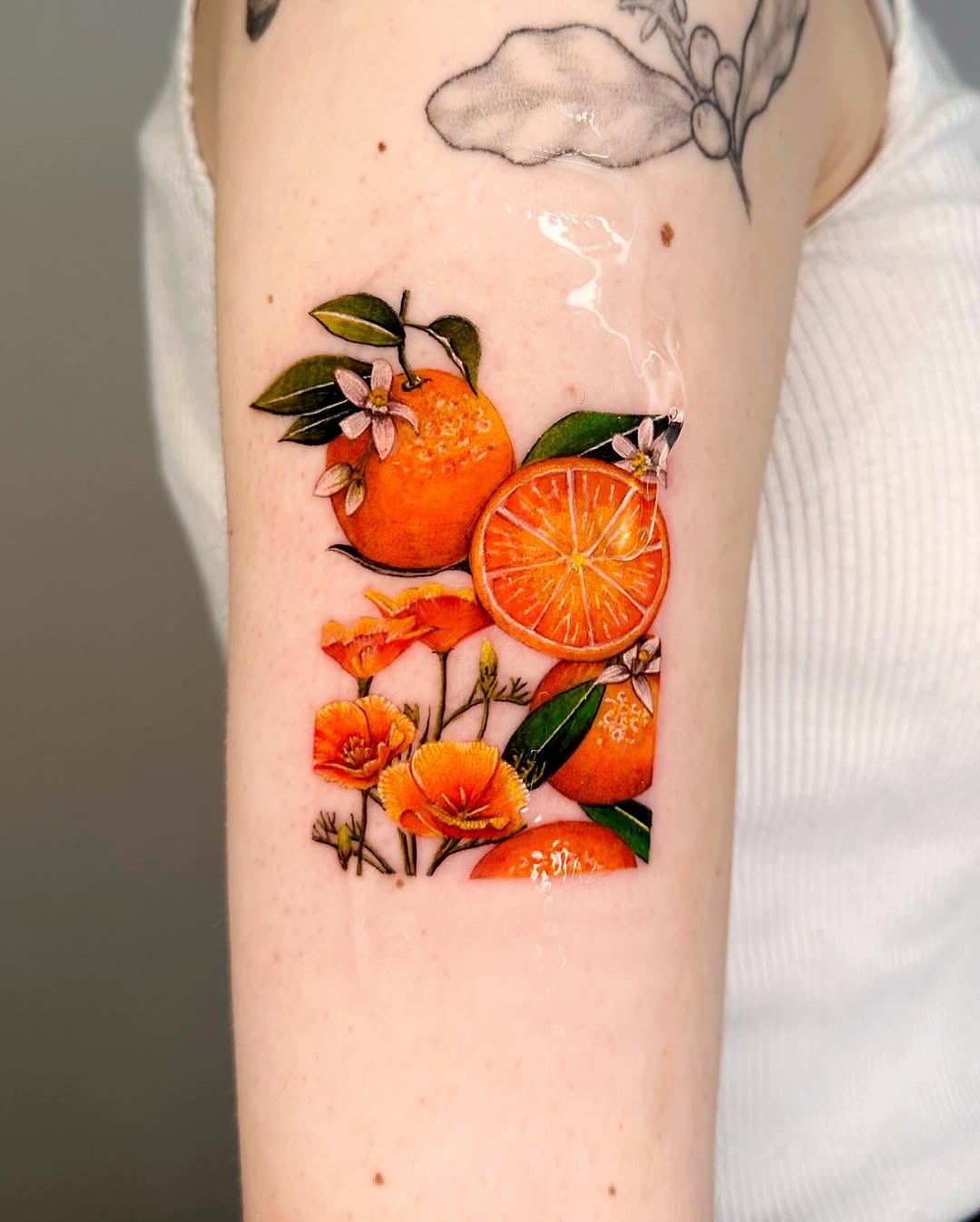 Vibrant lemon tattoo with floral elements Tattoo Design