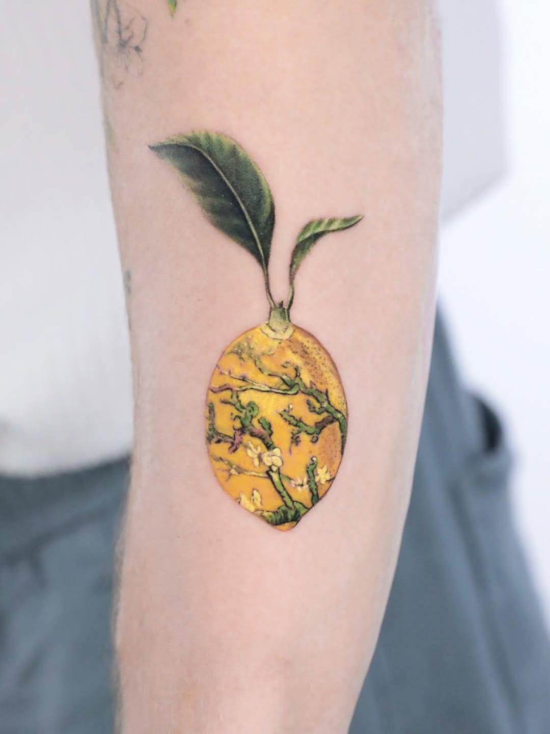 Whimsical Lemon Tattoo with Leaf Design Tattoo Design
