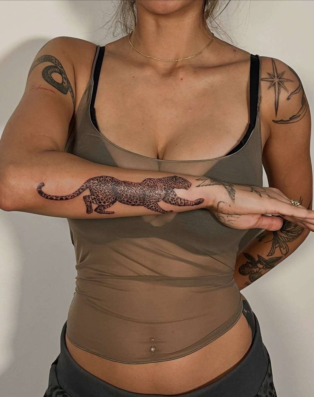 Elegant leopard tattoo on a woman's arm Tattoo Design