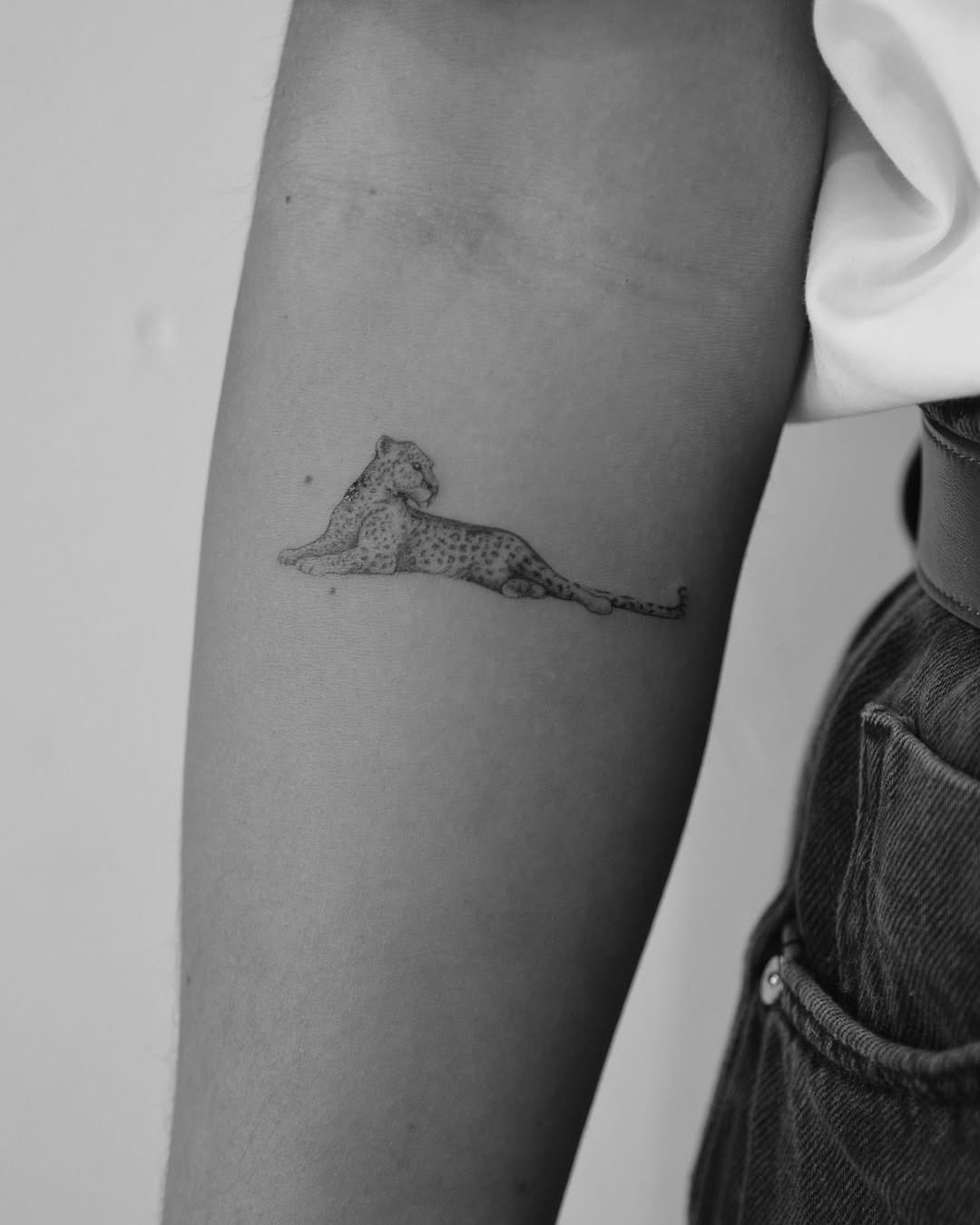 Elegant minimalist leopard tattoo on the arm Tattoo Design
