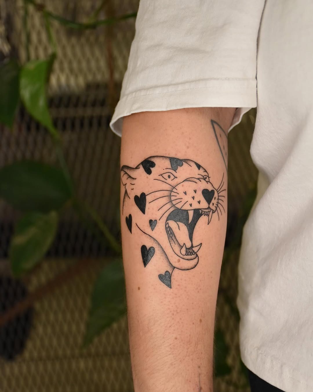 Striking black leopard tattoo with heart accents Tattoo Design