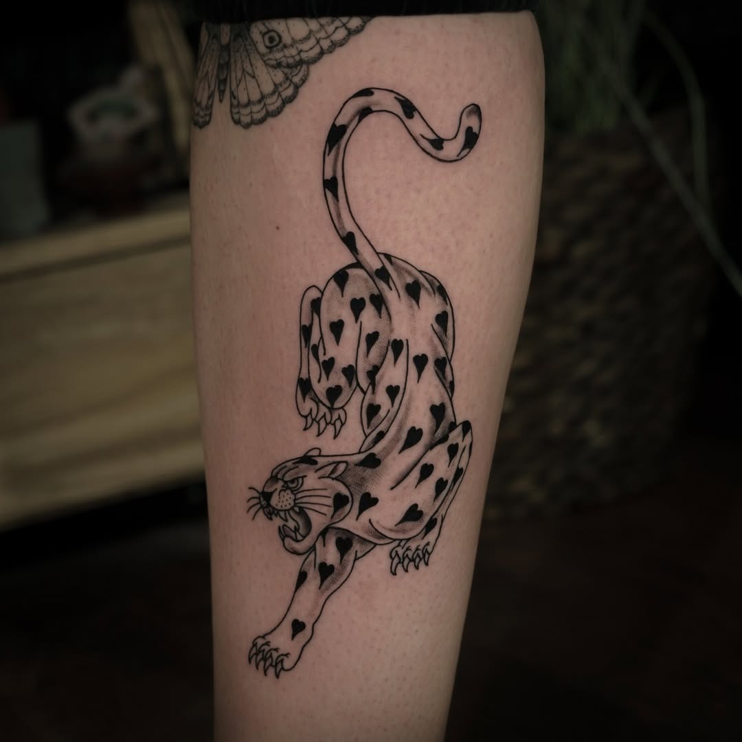 Striking leopard tattoo with heart patterns Tattoo Design