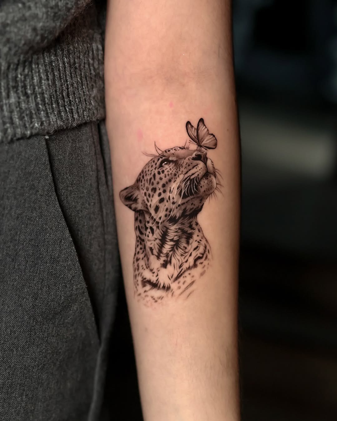 Stunning leopard tattoo with a butterfly accent Tattoo Design