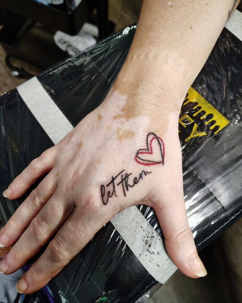 Let Them Tattoo with Bold Red Heart on Hand Tattoo Design