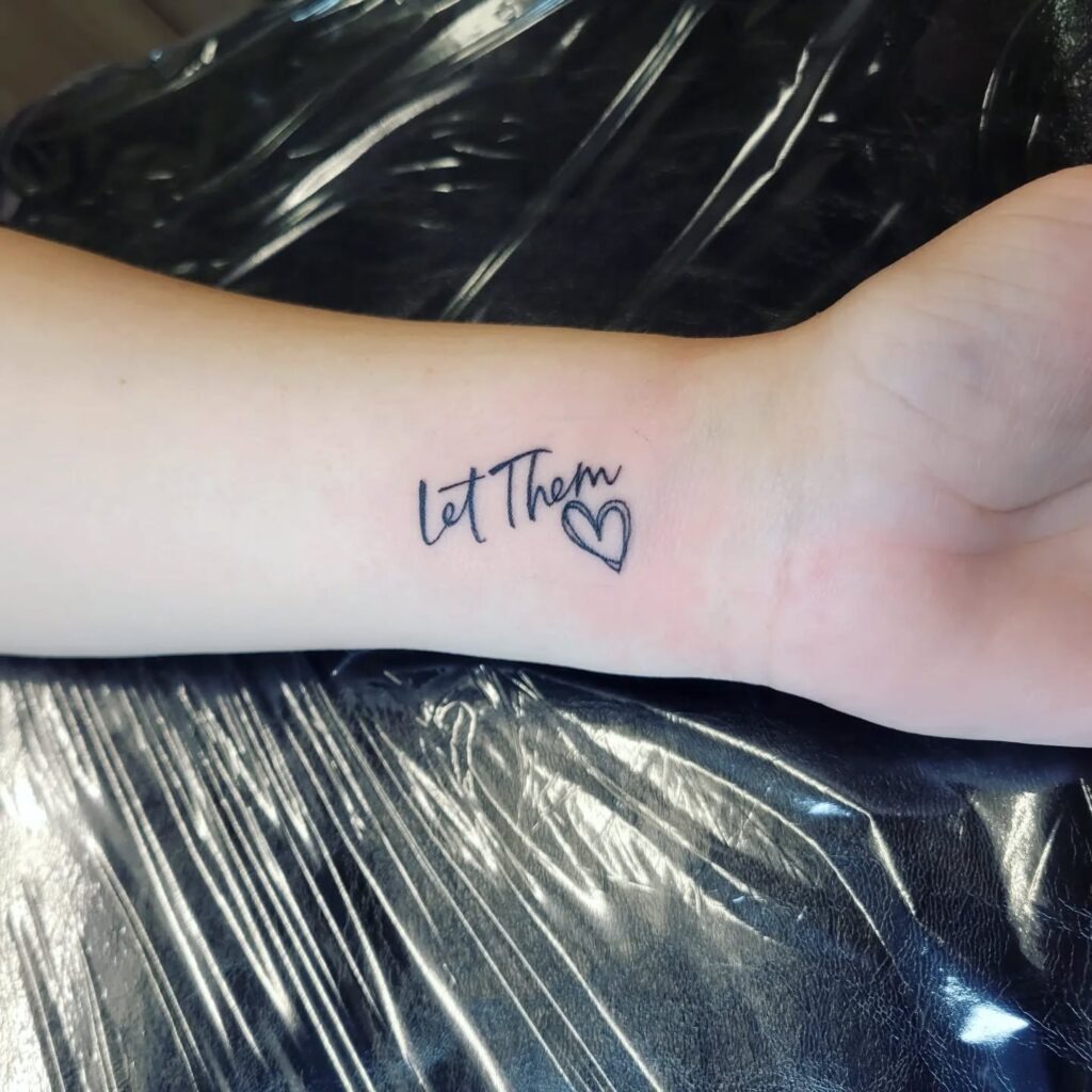 Let Them Wrist Tattoo with Open Heart and Capital Detail Tattoo Design