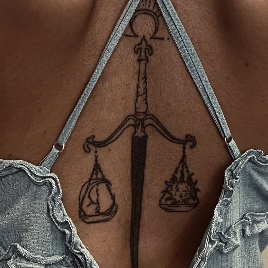 This tattoo features beautifully illustrated Libra scales, symbolizing balance and harmony.