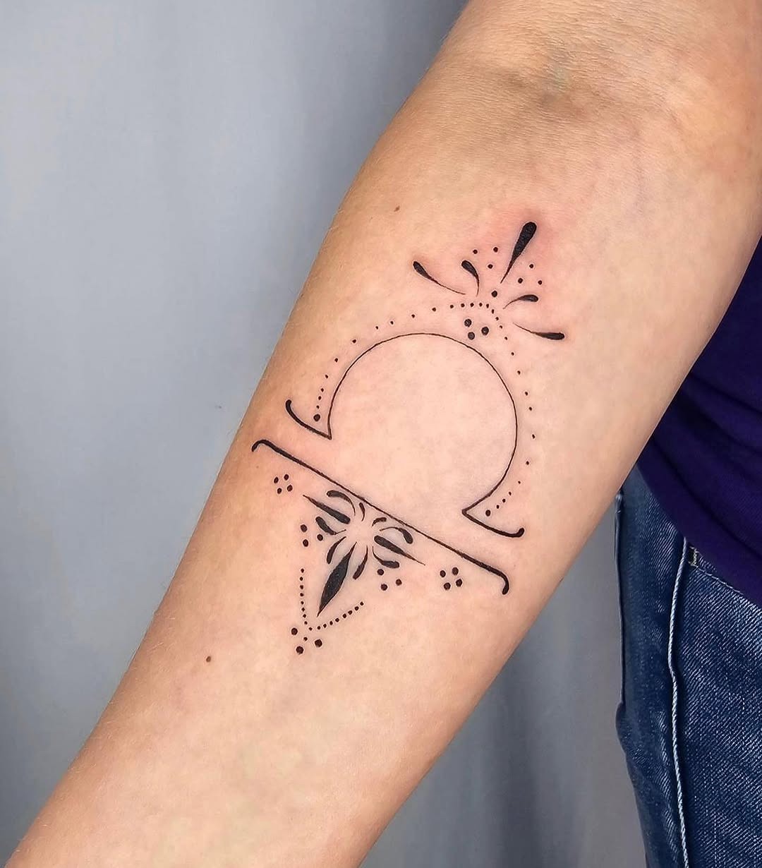 This Libra tattoo features a beautiful minimalist design characterized by fine black lines.