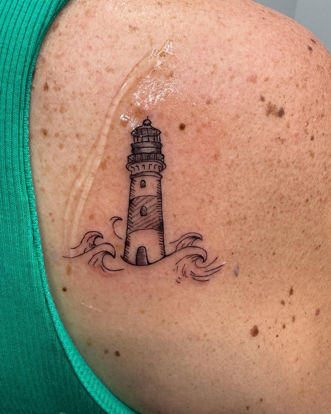 A stunning lighthouse surrounded by gentle waves. Tattoo Design