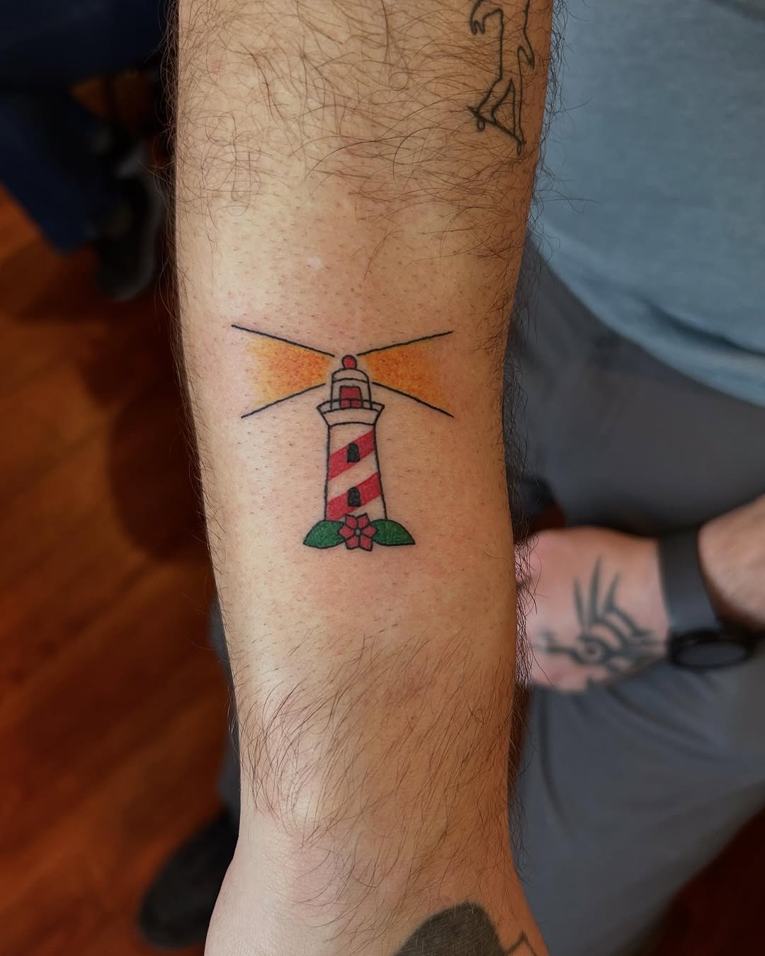Colorful lighthouse tattoo with floral accents Tattoo Design