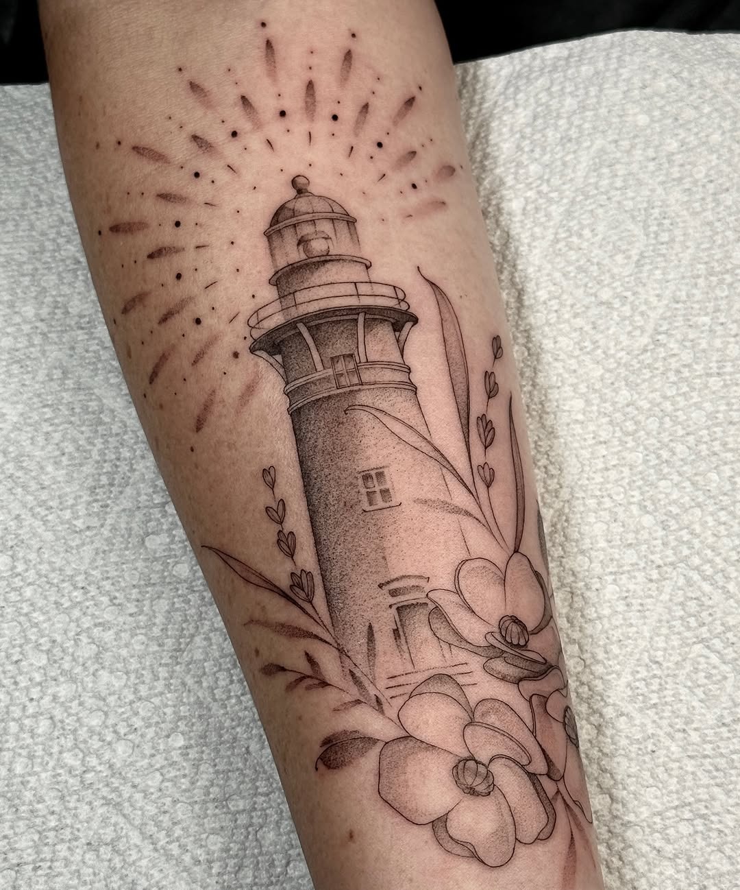Elegant lighthouse inked with floral motifs Tattoo Design