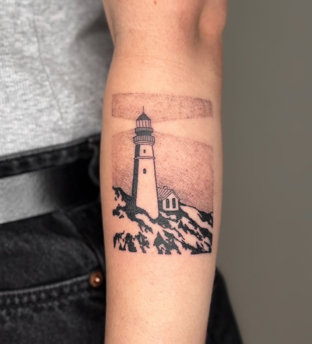 Elegant lighthouse tattoo set against a serene sky Tattoo Design