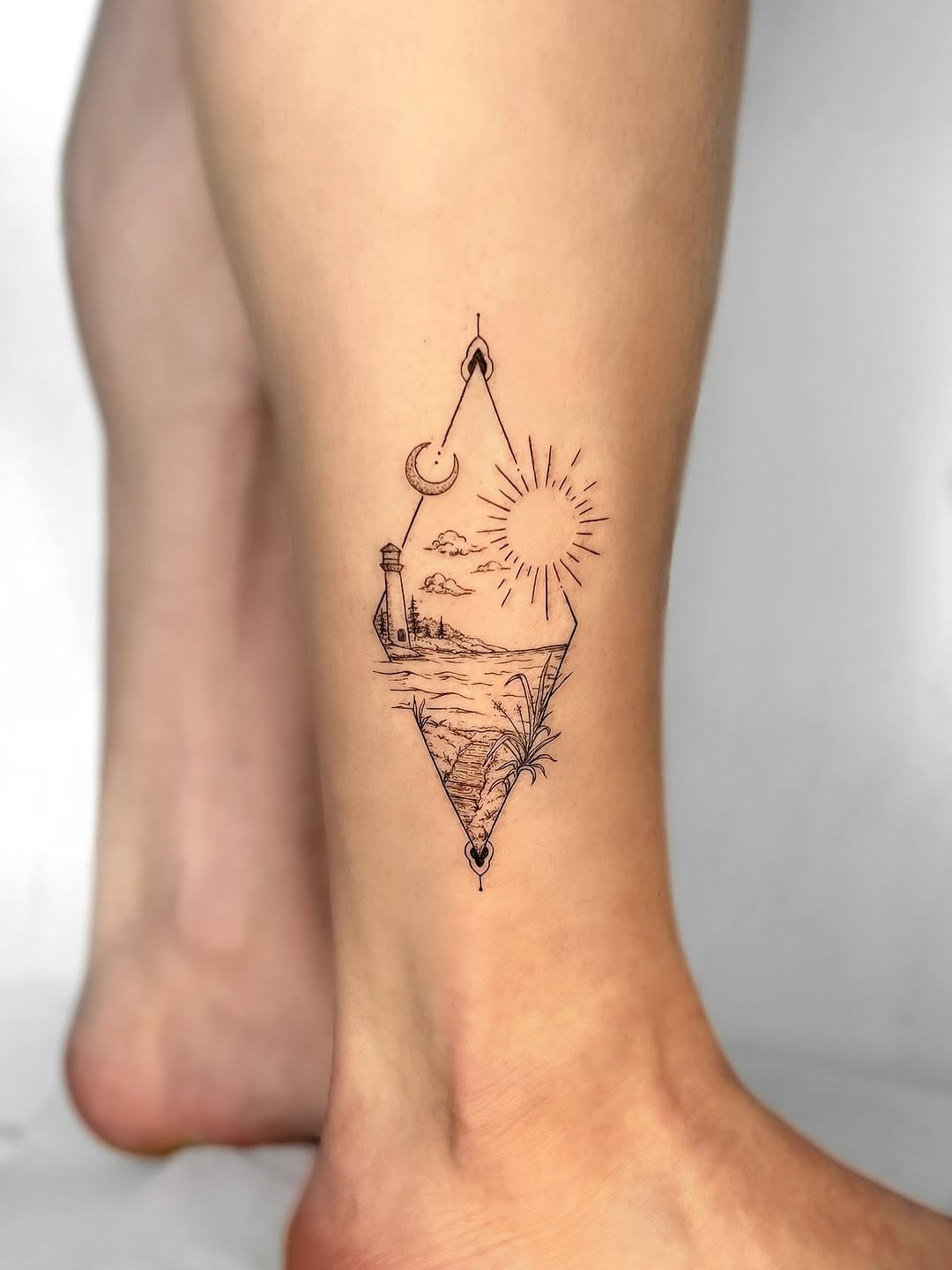 Intricate lighthouse tattoo with scenic elements Tattoo Design