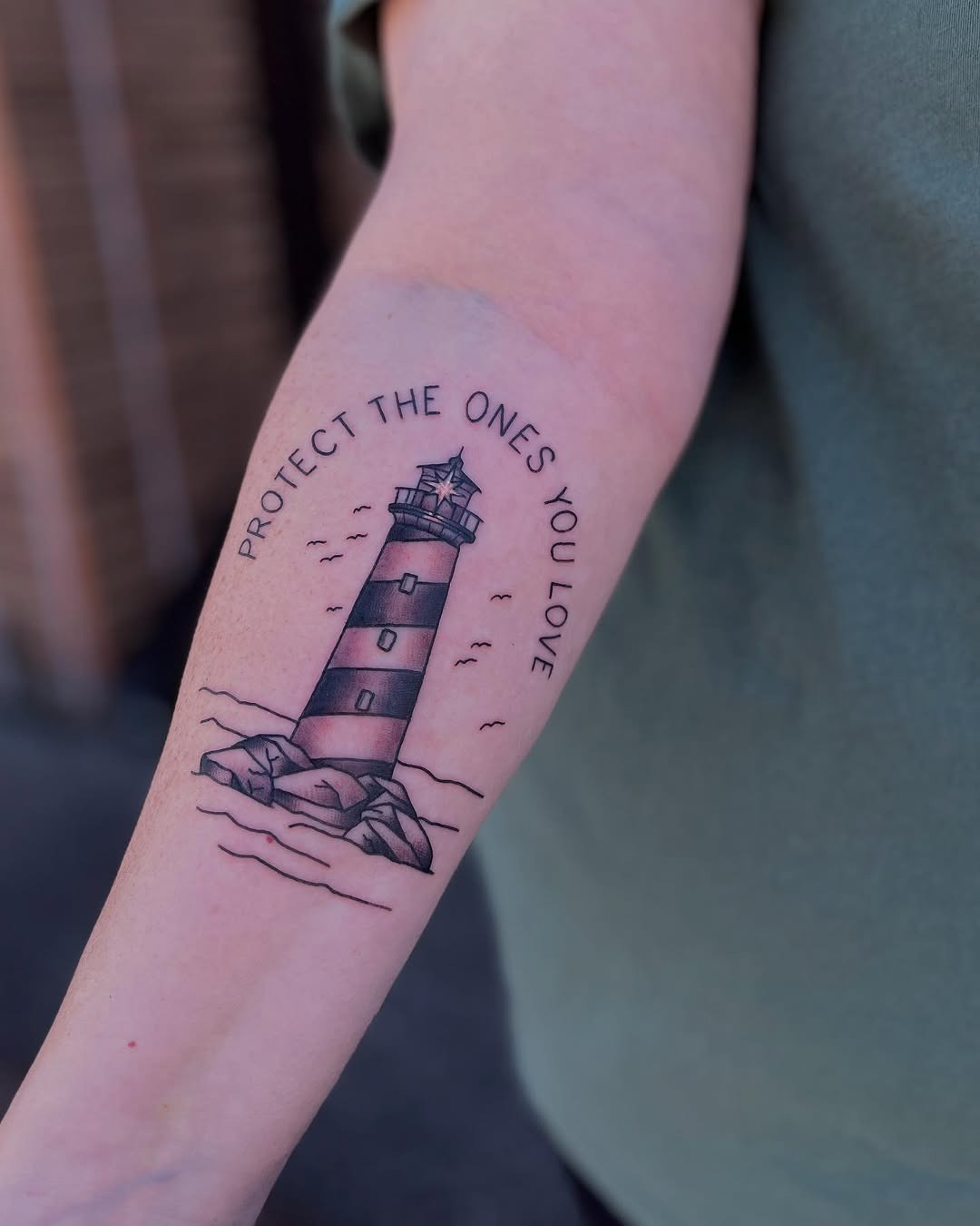 Meaningful lighthouse tattoo with protective message Tattoo Design