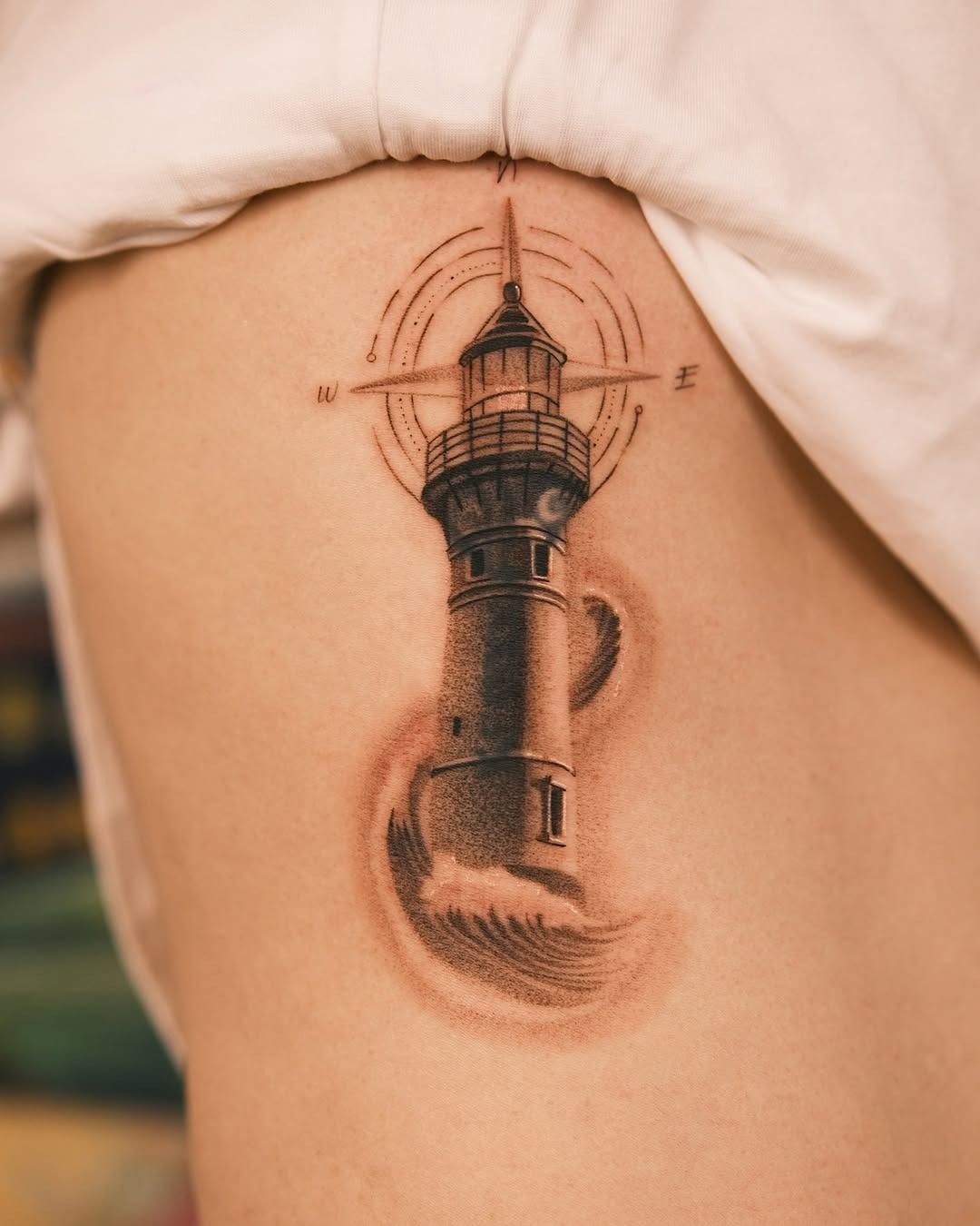 Nautical lighthouse tattoo with wave details Tattoo Design