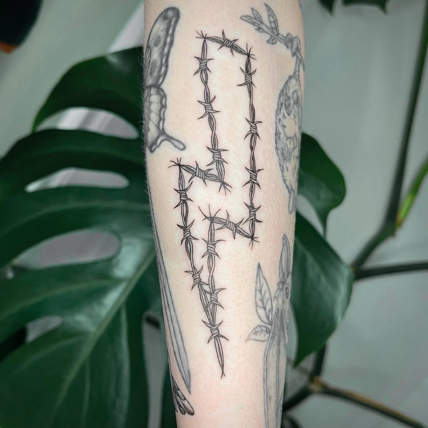 Edgy lightning bolt entwined with barbed wire Tattoo Design