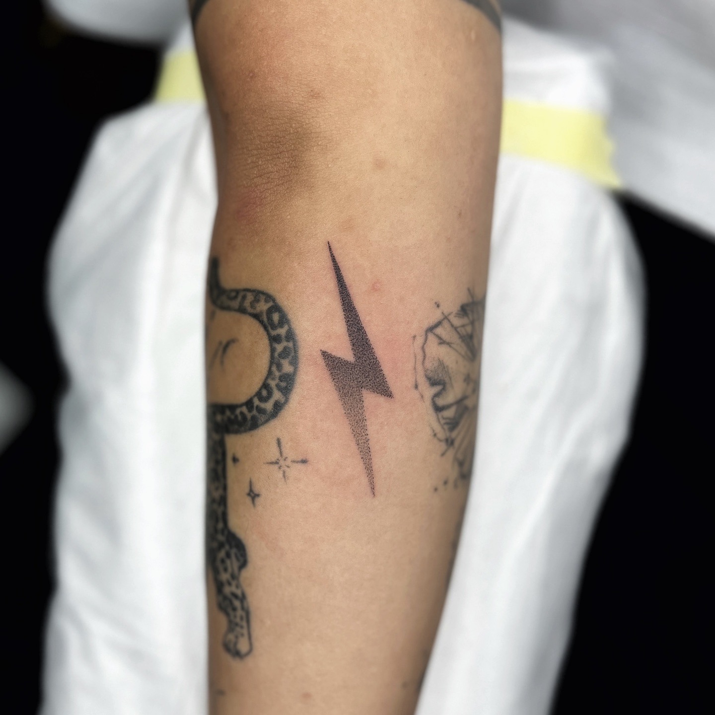 Minimalist lightning bolt tattoo on forearm Tattoo Design