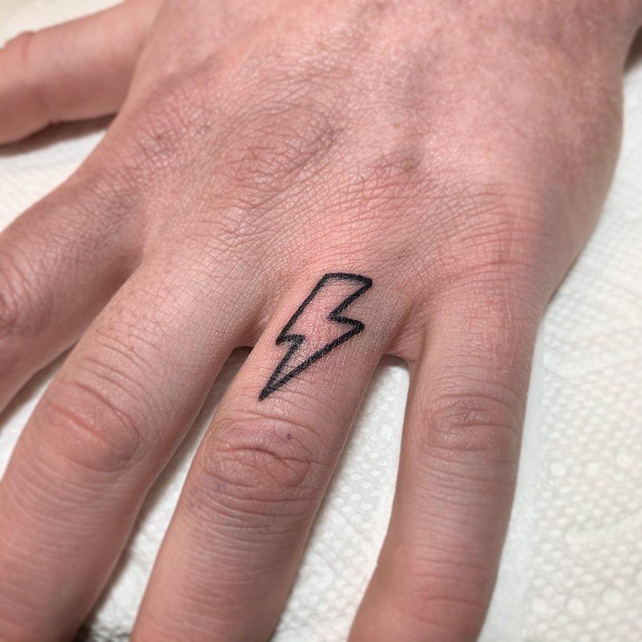 Minimalist lightning bolt tattoo on hand Tattoo Design