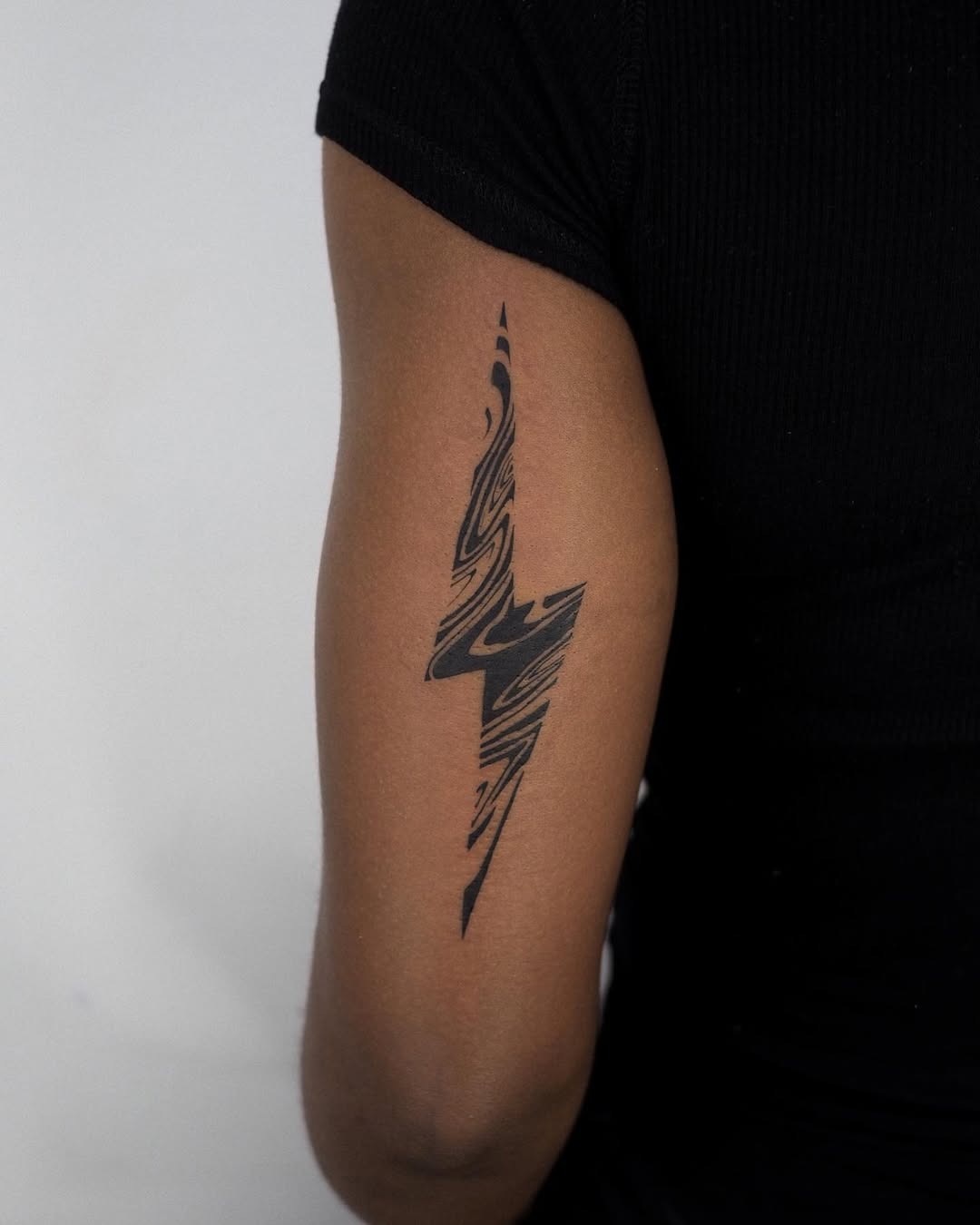 Sleek lightning bolt tattoo in abstract style Tattoo Design