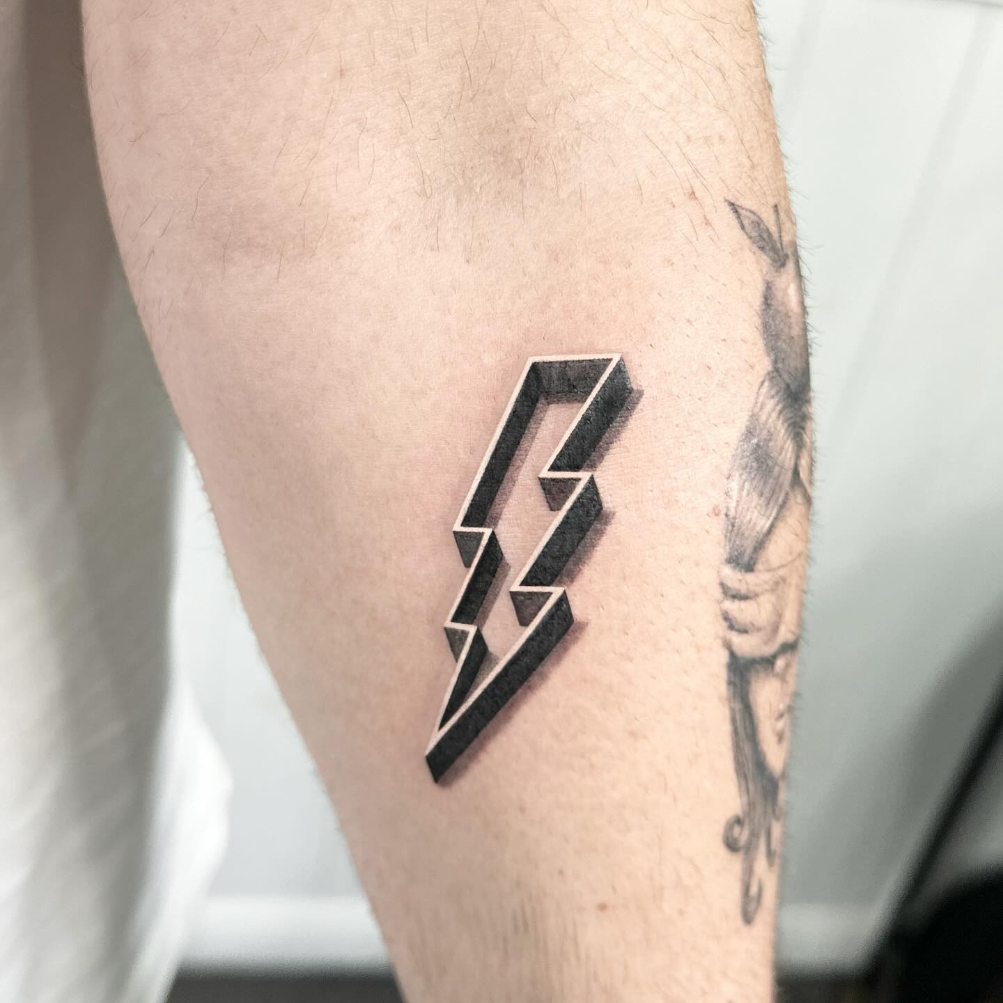 Sleek lightning bolt tattoo on the forearm Tattoo Design