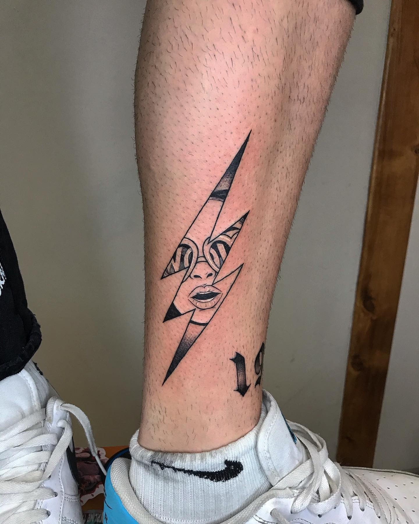 Striking lightning bolt tattoo featuring a face Tattoo Design
