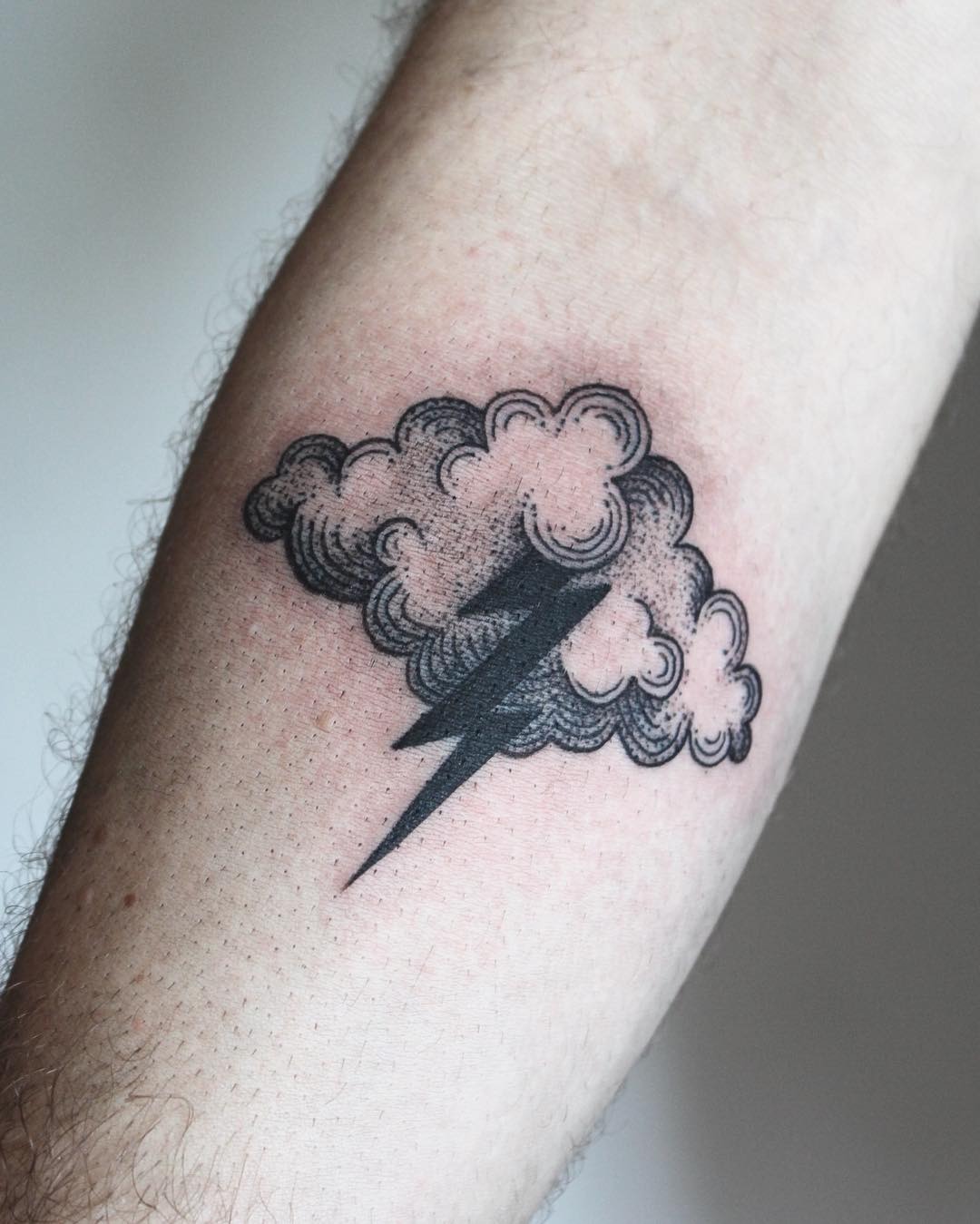 Stylish lightning bolt tattoo amidst cloudy design Tattoo Design