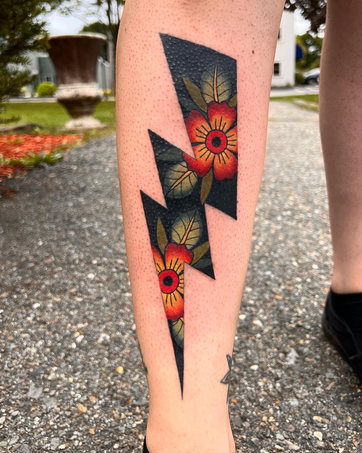 Vibrant lightning bolt tattoo with floral accents Tattoo Design
