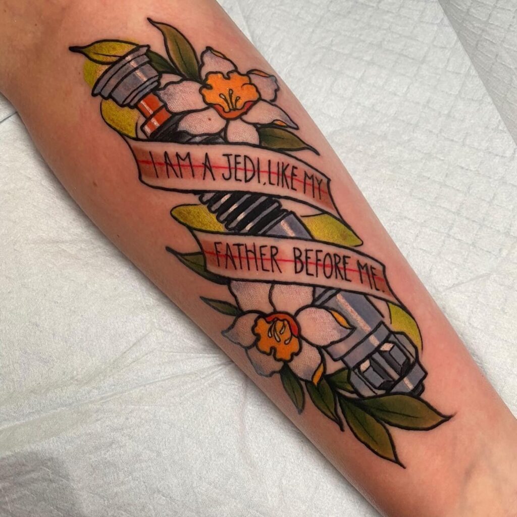 Jedi Legacy Lightsaber Tattoo with Quote and Flowers Tattoo Design