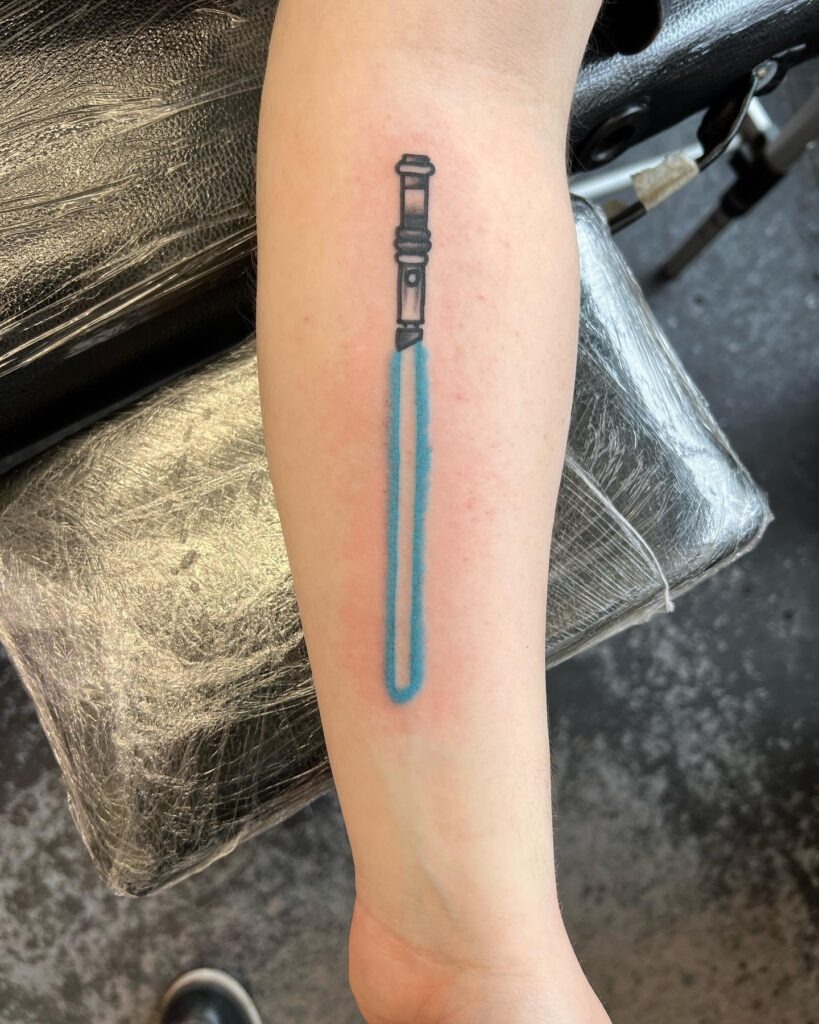 Obi-Wan Kenobi Lightsaber Tattoo with "High Ground" Banner Tattoo Design