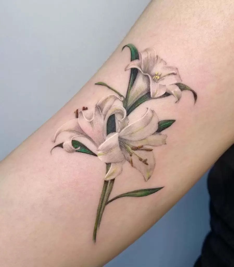 Minimalism at its best, this single-line lily tattoo is perfect for those who want a simple and small design.