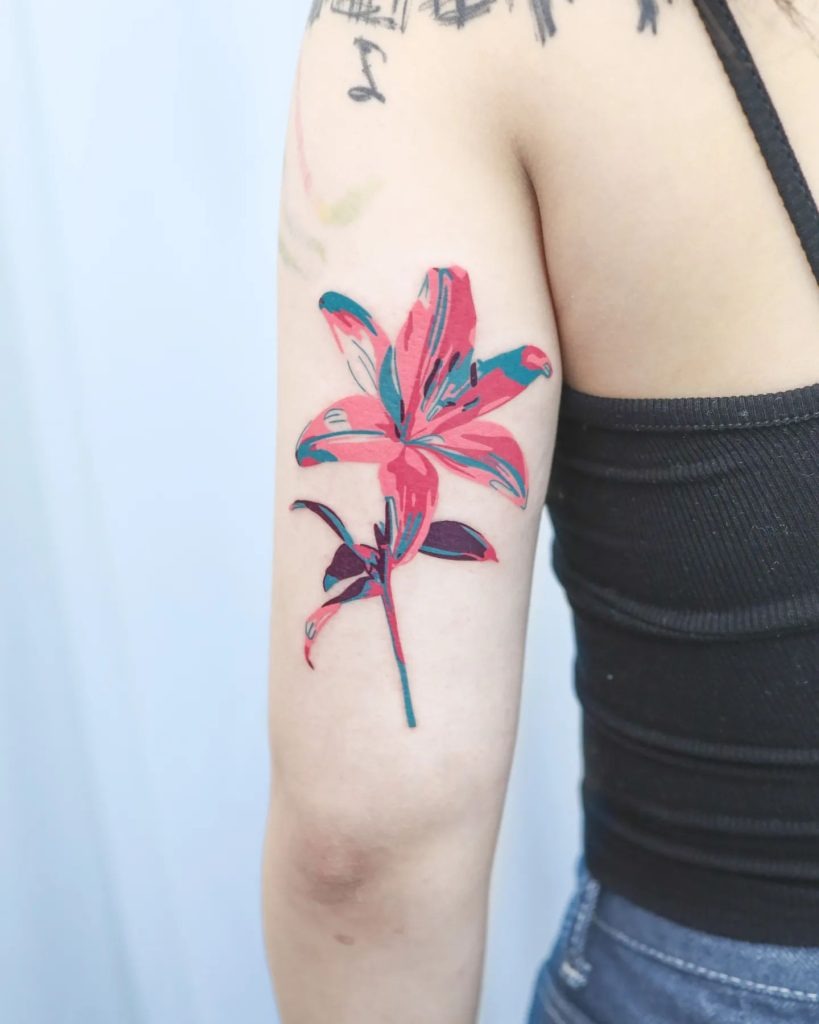 For those who enjoy a pop of color, this abstract lily tattoo is a striking choice.