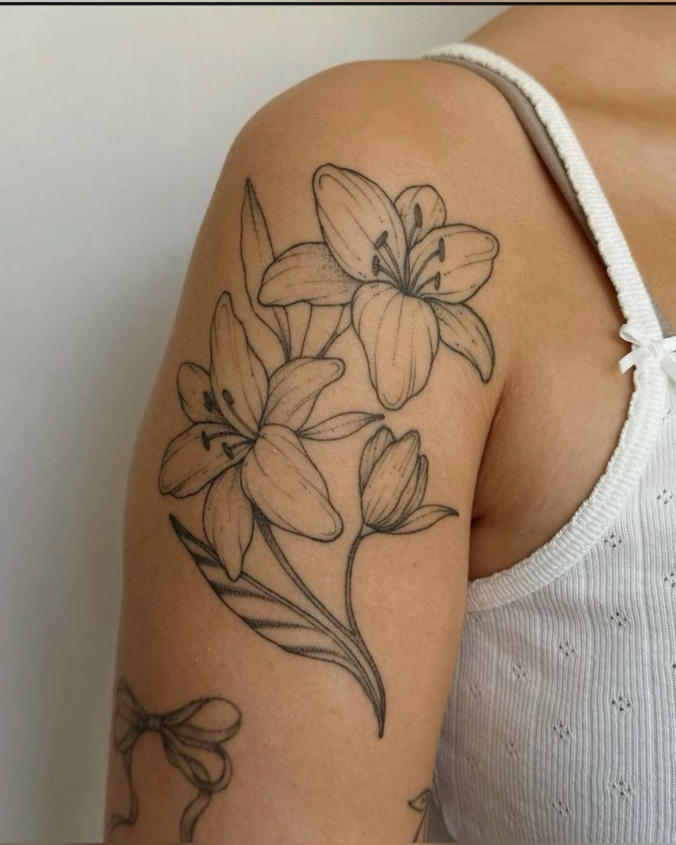 Delicate Lily Sketch Tattoo, a tattoo design rendered in clean detailed linework for the hand.